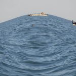 A photograph of the ocean with a fish-eye filter.