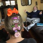 A photograph of a woman wearing a lot of barettes.