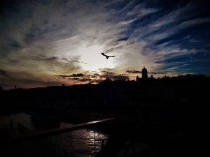 A photograph of a city skyline silhouetted at sunset.