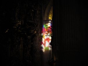 A photograph of a carved column lit up at night.