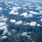 An aerial photograph of clouds over a landscape.