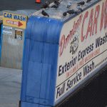 A photograph of a dingy car wash sign.
