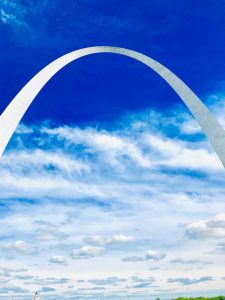 A photograph of an enormous arch in the sky.