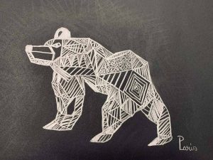 A pencil drawing on black paper of an abstract bear drawn in shapes.
