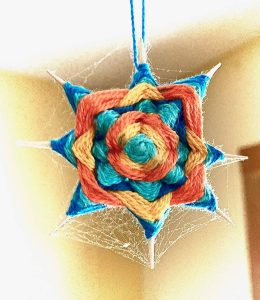 Photograph of a multicolored knitted design resembling an 8-point star
